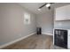 Bonus room with tiled floor, wet bar, white cabinets, and ceiling fan at 9618 N 55Th St, Temple Terrace, FL 33617