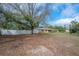 Expansive front yard enclosed by a white fence, offering privacy and ample space at 9618 N 55Th St, Temple Terrace, FL 33617