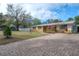 Charming single-story residence with a brick driveway and beautifully landscaped front yard at 9618 N 55Th St, Temple Terrace, FL 33617