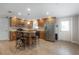 Well-lit kitchen with stainless steel appliances and a breakfast bar at 9618 N 55Th St, Temple Terrace, FL 33617
