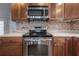 Stainless steel range beneath a microwave and custom tile backsplash add elegance to the kitchen at 9618 N 55Th St, Temple Terrace, FL 33617