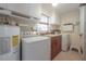 Laundry room with modern washer and dryer, sink, and storage cabinets at 9618 N 55Th St, Temple Terrace, FL 33617