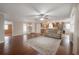 Open-concept living room with hardwood floors, ceiling fan and kitchen view at 9618 N 55Th St, Temple Terrace, FL 33617