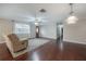 Bright living room with hardwood floors and a ceiling fan near the front door at 9618 N 55Th St, Temple Terrace, FL 33617