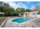 A refreshing pool nestled within a spacious brick patio and featuring a detached garage at 9618 N 55Th St, Temple Terrace, FL 33617
