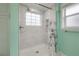 Beautiful tiled shower with a window, niche, and modern fixtures at 9618 N 55Th St, Temple Terrace, FL 33617