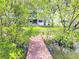 Scenic view of the property from the dock, surrounded by lush greenery and waterfront at 9914 Indian Key Trl # 32, Seminole, FL 33776