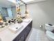 Stylish bathroom featuring double sinks, elegant fixtures, and decorative tile accents at 9914 Indian Key Trl # 32, Seminole, FL 33776