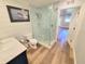 Updated bathroom with a patterned glass shower enclosure and modern vanity at 9914 Indian Key Trl # 32, Seminole, FL 33776