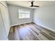 Neutral bedroom boasts stylish dark wood floors, a ceiling fan, and ample natural light at 9914 Indian Key Trl # 32, Seminole, FL 33776