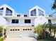 Well-maintained townhome with a two-car garage and landscaped front yard at 9914 Indian Key Trl # 32, Seminole, FL 33776