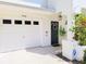 Charming front exterior with a garage, inviting front door, and beautiful landscaping at 9914 Indian Key Trl # 32, Seminole, FL 33776