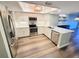 Modern kitchen featuring stainless steel appliances, white cabinets and a stylish backsplash at 9914 Indian Key Trl # 32, Seminole, FL 33776