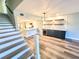Stylish living room with hardwood floors, staircase and recessed lighting at 9914 Indian Key Trl # 32, Seminole, FL 33776