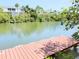 Beautiful water view featuring docks and a tranquil waterway surrounded by lush greenery at 9914 Indian Key Trl # 32, Seminole, FL 33776