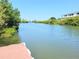 Picturesque waterway with docks, mature trees, and clear blue sky at 9914 Indian Key Trl # 32, Seminole, FL 33776