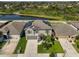 Aerial view of the home with solar panels, a well-maintained yard, and proximity to a pond at 10112 Rose Petal Pl, Riverview, FL 33578