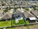 Aerial view of the backyard with a patio, fire pit, artificial grass, and a white fence at 10112 Rose Petal Pl, Riverview, FL 33578