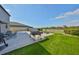 Spacious backyard featuring lush artificial turf, an outdoor grill, patio, and a cozy fire pit area at 10112 Rose Petal Pl, Riverview, FL 33578