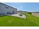 Backyard with artificial turf, patio, BBQ grill, privacy fence, and a comfortable seating area with a fire pit at 10112 Rose Petal Pl, Riverview, FL 33578