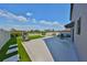 Beautiful backyard with a patio, artificial turf, modern seating, and pristine white fences at 10112 Rose Petal Pl, Riverview, FL 33578