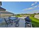 Inviting backyard patio with outdoor dining set, grill, and artificial turf for recreation and relaxation at 10112 Rose Petal Pl, Riverview, FL 33578