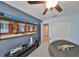 Bedroom featuring ceiling fan, carpet, large flat screen TV on console table, a sofa, and a bean bag chair at 10112 Rose Petal Pl, Riverview, FL 33578