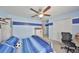 Bright bedroom with blue striped walls, ceiling fan, carpet, closet, and a bed with blue striped bedding at 10112 Rose Petal Pl, Riverview, FL 33578