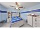 Bedroom with hardwood floors, ceiling fan, bed with attached storage and built-in shelving at 10112 Rose Petal Pl, Riverview, FL 33578