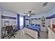 Bedroom with hardwood floors, ceiling fan, bed with attached storage and built-in shelving at 10112 Rose Petal Pl, Riverview, FL 33578