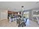 Open dining area with kitchen island, granite countertops, and patio access at 10112 Rose Petal Pl, Riverview, FL 33578