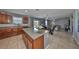 Open concept kitchen with island, granite countertops, and stainless appliances at 10112 Rose Petal Pl, Riverview, FL 33578