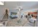 Open-concept living area with a staircase, plush sofas, and access to the kitchen at 10112 Rose Petal Pl, Riverview, FL 33578