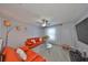 Bright living room with carpet, ceiling fan, unique lighting, comfortable red sofa set, and sheer window curtains at 10112 Rose Petal Pl, Riverview, FL 33578