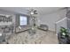 Living room featuring tile floors, large windows with sheer curtains, and comfortable seating at 10112 Rose Petal Pl, Riverview, FL 33578