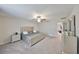 Relaxing main bedroom offers plush carpet, ceiling fan, dresser, and stylish bedframe with tufted headboard at 10112 Rose Petal Pl, Riverview, FL 33578