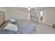 Relaxing main bedroom offers plush carpet, ceiling fan, dresser, stylish bedframe with tufted headboard, ensuite bathroom access at 10112 Rose Petal Pl, Riverview, FL 33578