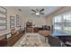 Office space with a ceiling fan, a large window, and a built-in bookcase at 10112 Rose Petal Pl, Riverview, FL 33578