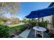 Relaxing outdoor patio with a blue umbrella and a view of the lake at 11511 113Th St # 25A, Largo, FL 33778