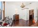 Cozy living room with hardwood floors, vintage light fixture, and decorative furniture in a vintage style home at 1207 E Columbus Dr, Tampa, FL 33605