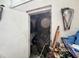View through an open doorway into a cluttered room, with various disorganized items and debris visible at 12588 128Th Ave, Largo, FL 33774