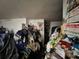Interior view of a room piled high with disorganized clothing and debris at 12588 128Th Ave, Largo, FL 33774