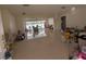 Spacious living room with tile flooring and access to the screened-in pool area at 13913 Dominica Dr, Seminole, FL 33776