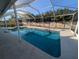 Inviting enclosed pool with clean lines, complemented by a secure screened enclosure and concrete deck at 13913 Dominica Dr, Seminole, FL 33776
