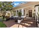 Inviting front porch with brick steps and white brick supports, framed by lush trees and greenery at 140 16Th Ne Ave, St Petersburg, FL 33704