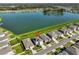 Aerial view of a home near a lake, showcasing a well-maintained yard and neighborhood at 1407 Tropical Oasis Ave, Plant City, FL 33565