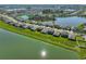 Aerial view of a community with homes lining a scenic lake at 1407 Tropical Oasis Ave, Plant City, FL 33565