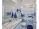 Cozy bathroom boasting a granite countertop vanity, decorative mirror and blue accents including artwork and towels at 1407 Tropical Oasis Ave, Plant City, FL 33565