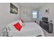 Cozy bedroom with neutral walls, plush bedding, and a serene view from the bright window at 1407 Tropical Oasis Ave, Plant City, FL 33565
