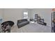 Spacious bedroom designed with neutral tones, offering a futon, window with natural light, and unique decor at 1407 Tropical Oasis Ave, Plant City, FL 33565